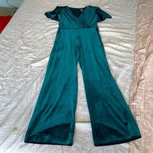 Green velvet jumpsuit with pockets, belt, and cap sleeves